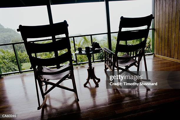two rocking chairs and table on balcony - timothy stock pictures, royalty-free photos & images