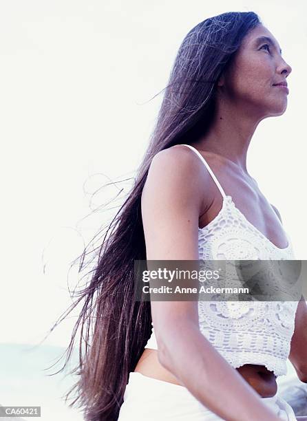 woman with long hair outdoors, profile - a testa alta foto e immagini stock