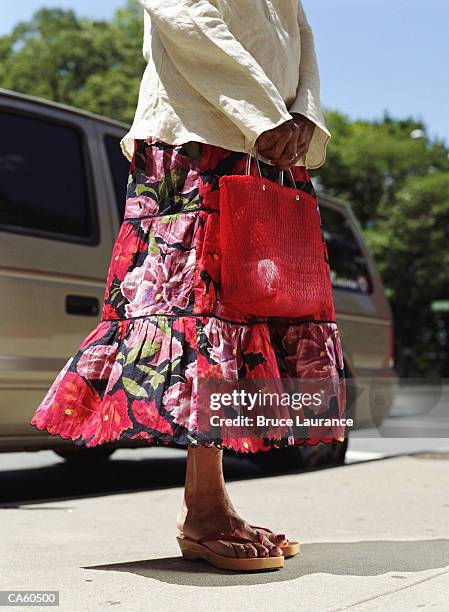 mature woman with red hand bag, low section - zondagse kleren stockfoto's en -beelden