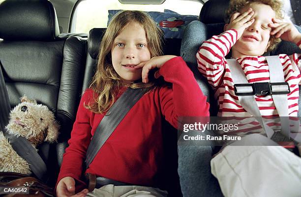 boy and girl (2-4) wearing seatbelt in car - kid car safety stock pictures, royalty-free photos & images