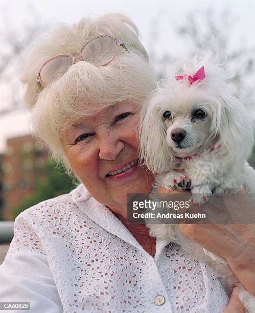 mature woman  holding dog - andreas kuehn bildbanksfoton och bilder