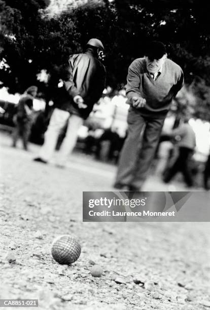 elderly man playing boules, france (b&w) - boule stock pictures, royalty-free photos & images