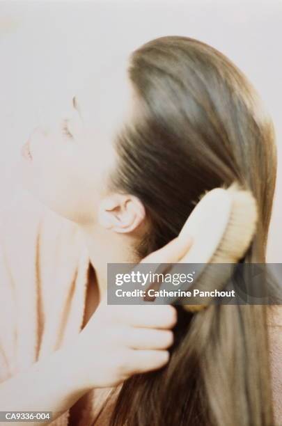 young woman brushing hair, close-up - brushing hair stock pictures, royalty-free photos & images