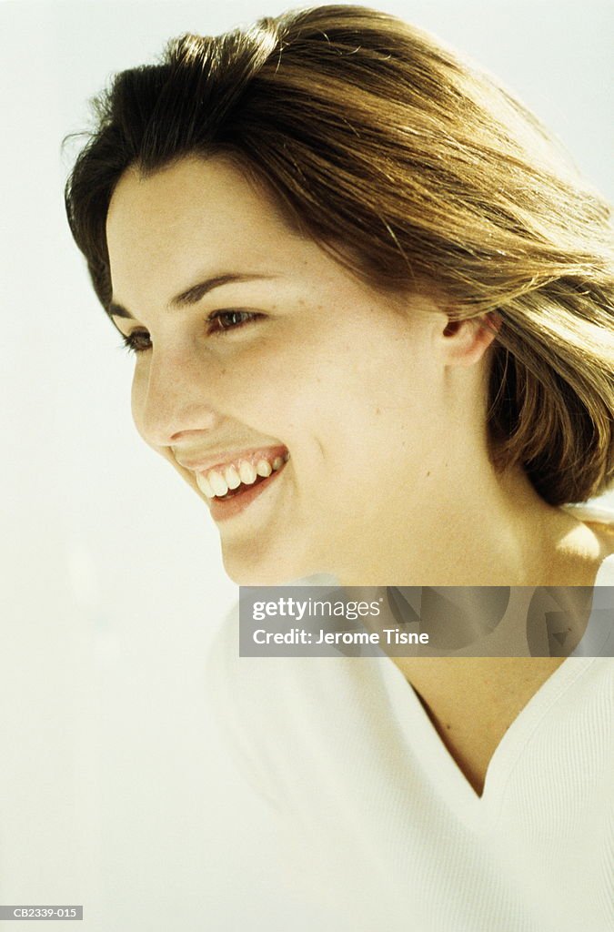 Young brunette woman, smiling, profile, portrait, close-up