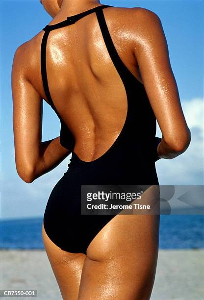 tanned young woman wearing swimming costume, rear view, close-up - swimwear 個照片及圖片檔