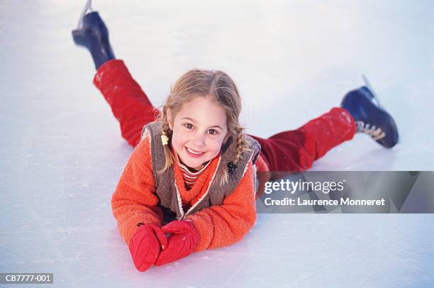 young girl (4-6) lying on ice, wearing ice-skates, portrait - ice rink stock-fotos und bilder