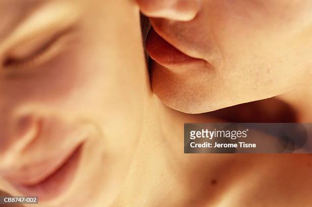 young couple, man kissing woman's neck, close-up - tomber amoureux photos et images de collection
