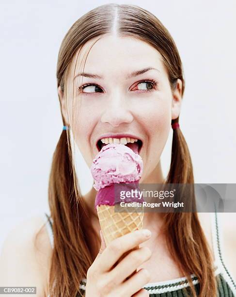 young woman eating ice-cream, close-up, portrait - njutningslystnad bildbanksfoton och bilder