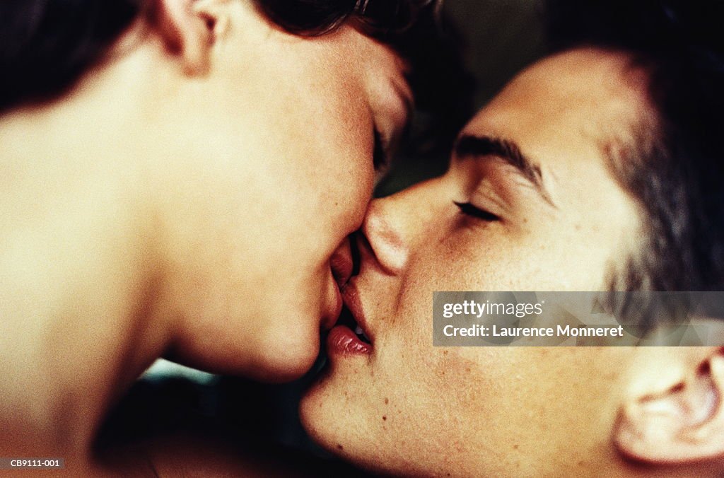 Teenage couple (16-18), kissing, close-up