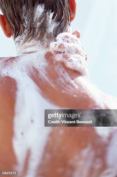 man washing neck in shower, close-up, rear view - hombre en la ducha fotografías e imágenes de stock