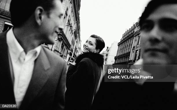 two men and woman smiling (focus on woman) (b&w) - leila stock pictures, royalty-free photos & images