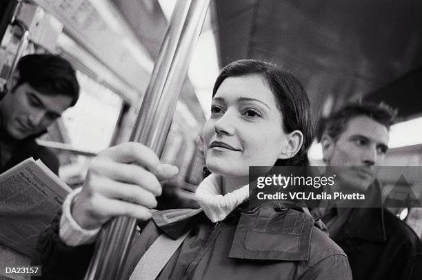 two men, and woman on train (focus on woman in foreground) - leila stock pictures, royalty-free photos & images