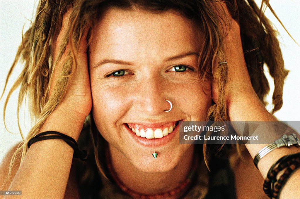 Young woman wearing nose and lip jewelry, portrait