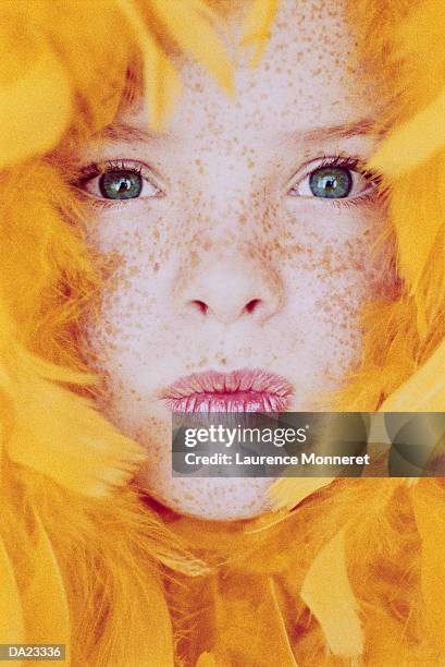 gril (7-9) surrounded by yellow feathers, close-up, portrait - gril stock pictures, royalty-free photos & images