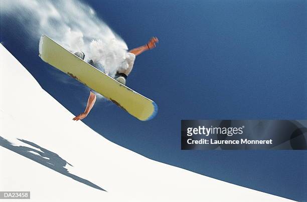 man sandboarding in mid-jump, low angle view - snowboard stock-fotos und bilder