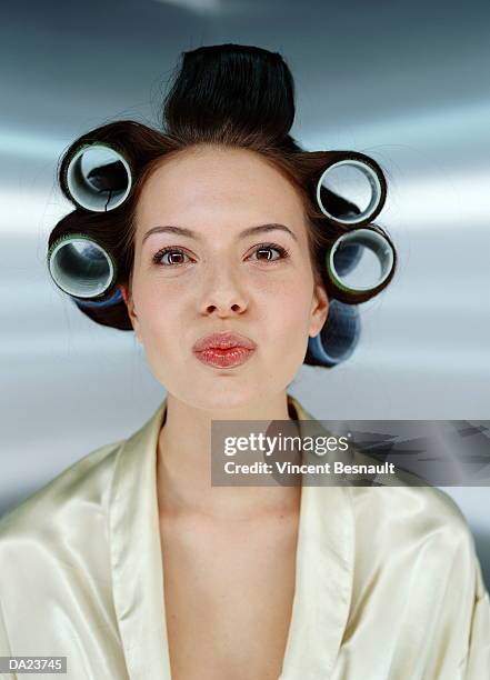 young woman wearing hair in curlers, portrait - hair curlers stockfoto's en -beelden