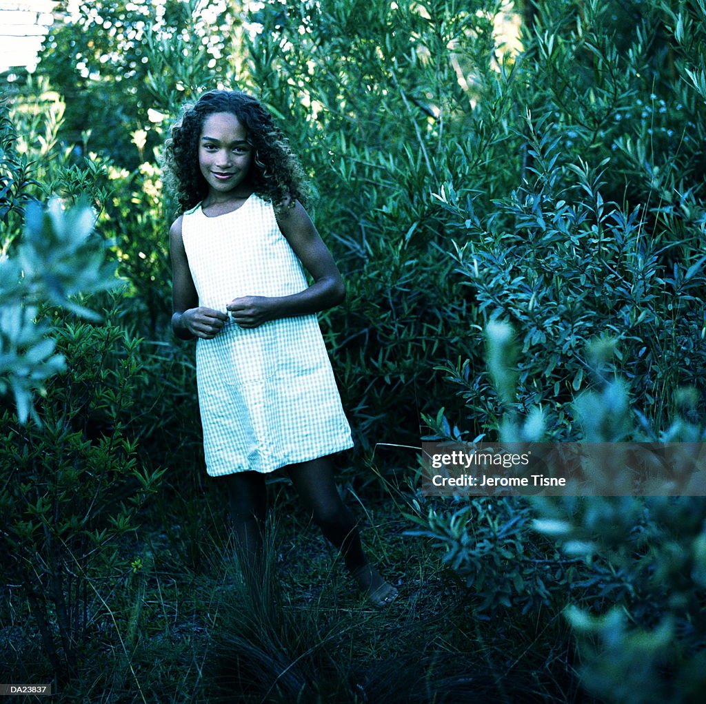Girl (7-9) smiling, outdoors, portrait (cross-processed, grainy)