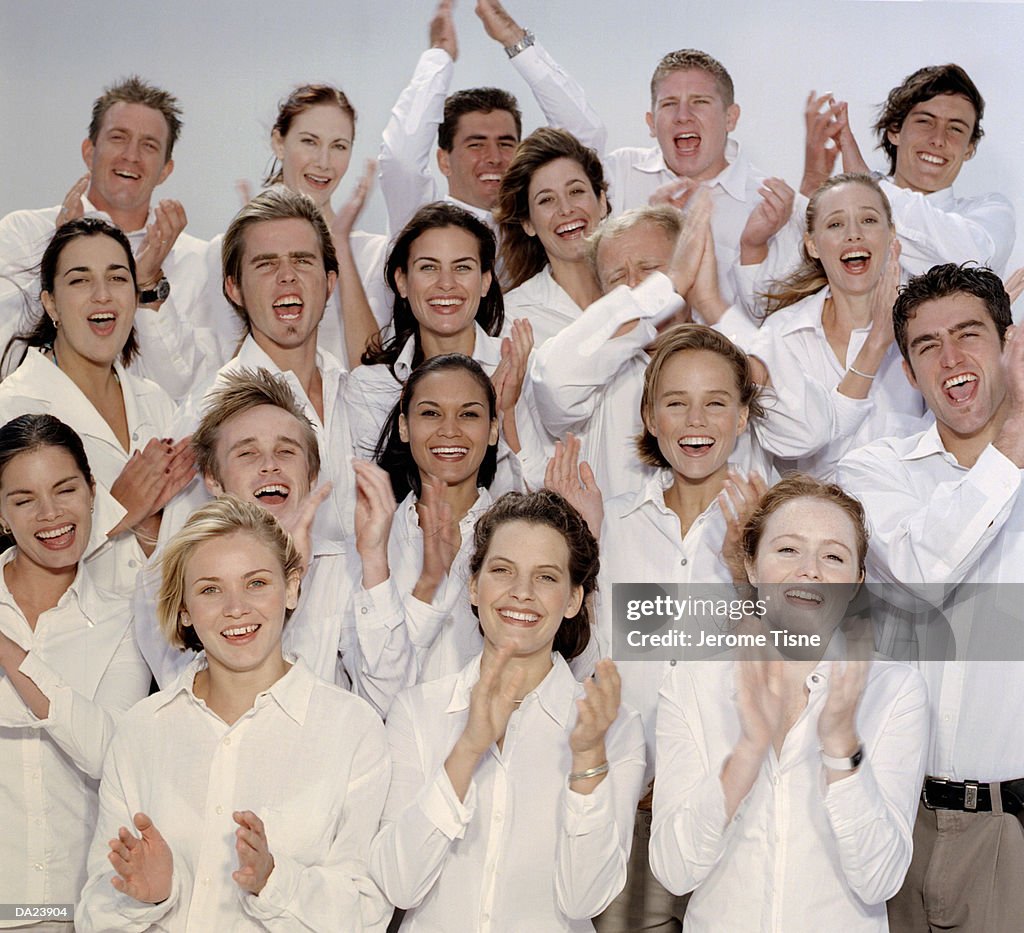 Group in white shirts clapping, high section, portrait
