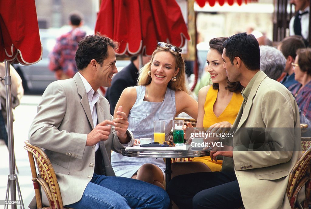 Two couples at cafe table