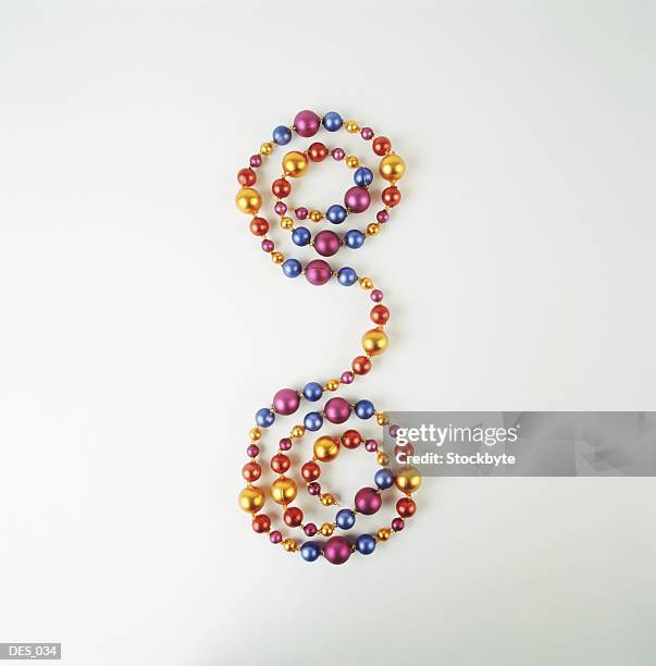 string of beads curled at both ends - bead string stock pictures, royalty-free photos & images