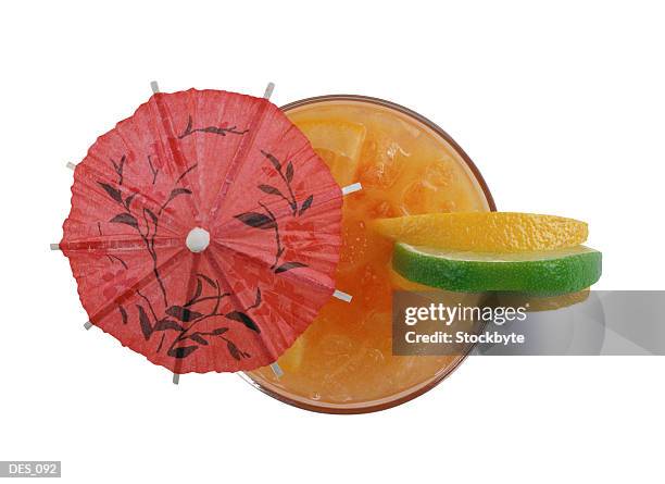 cocktail with paper umbrella and fruit garnish, overhead view - cocktail umbrella stock pictures, royalty-free photos & images