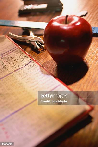 attendance list, apple, hole punch and ruler on desktop - hole punch stock pictures, royalty-free photos & images