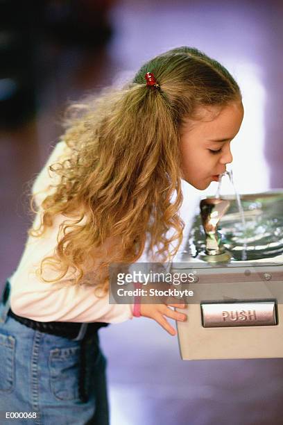 girl drinking from water fountain - drinking fountain stock pictures, royalty-free photos & images