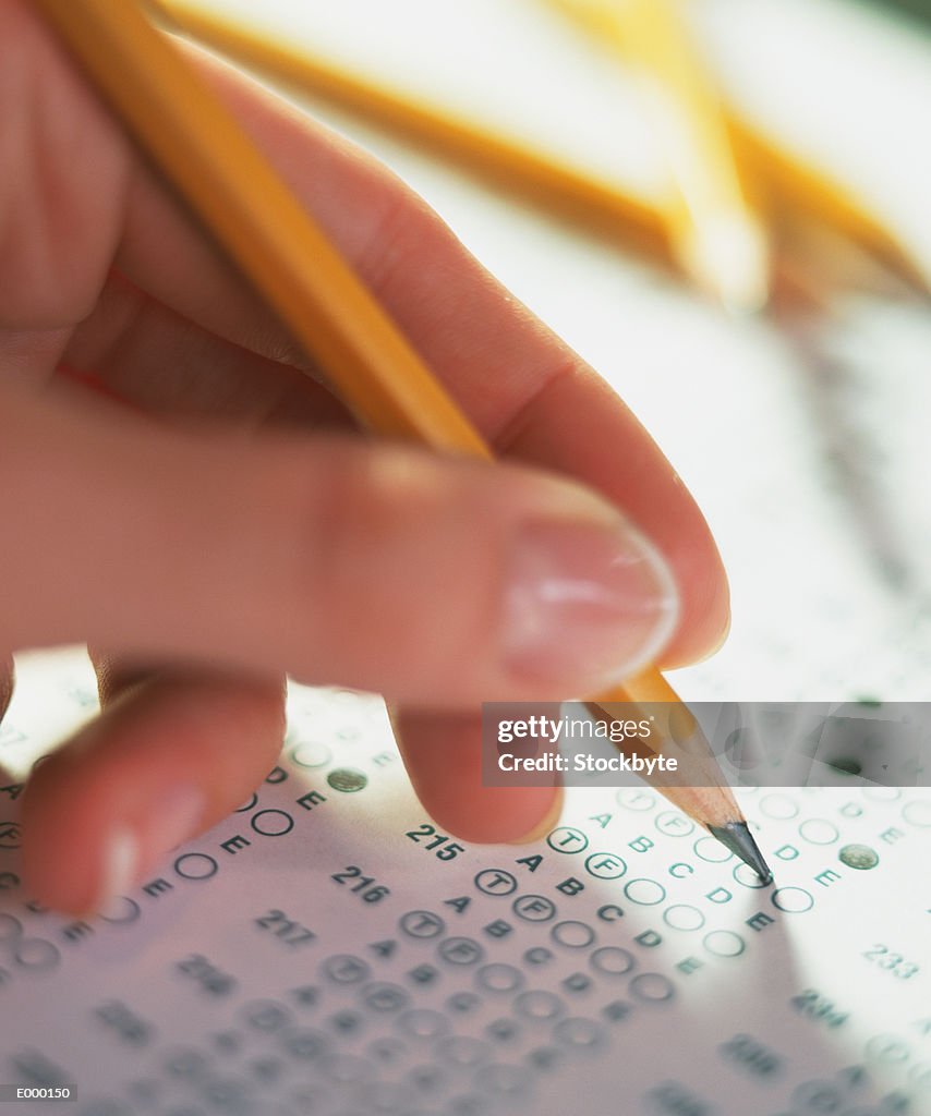 Hand filling in multiple choice test sheet