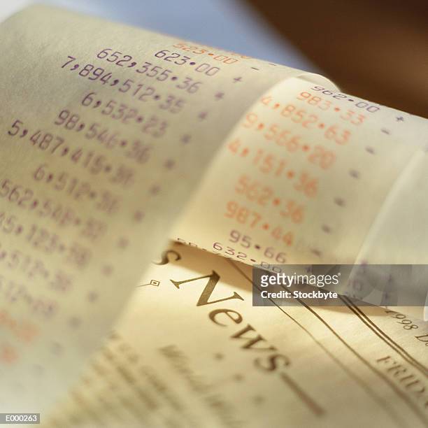 printout from adding machine on top of financial newspaper - broadsheet stock pictures, royalty-free photos & images