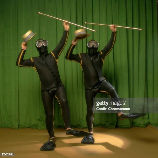 two men wearing wet suits, holding hats and canes, dancing on stage - dance cane stock pictures, royalty-free photos & images
