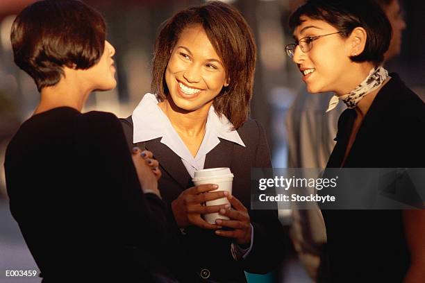 three women talking together - women talking stock pictures, royalty-free photos & images