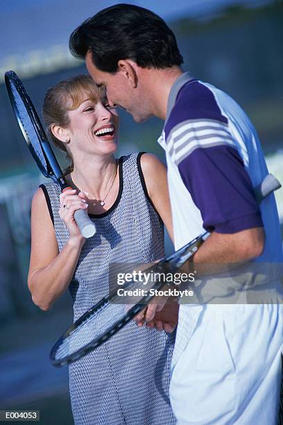 couple holding tennis rackets - sports competition format stock pictures, royalty-free photos & images