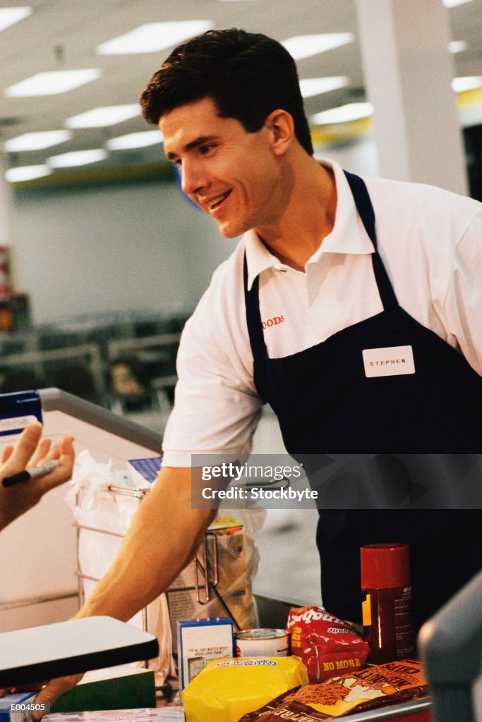 Clerk packing groceries