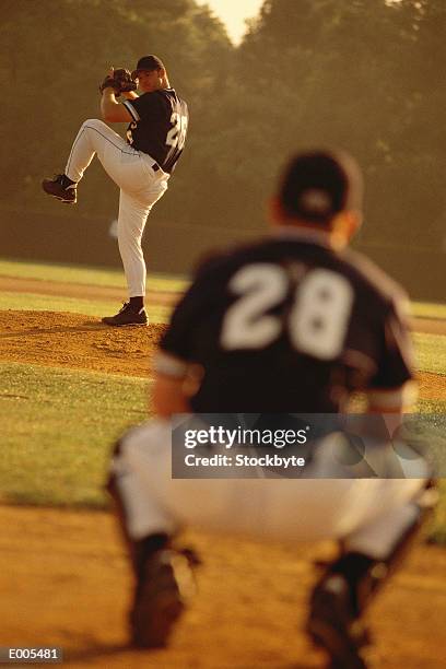 view from home plate of pitcher winding-up - baseball catcher stock pictures, royalty-free photos & images