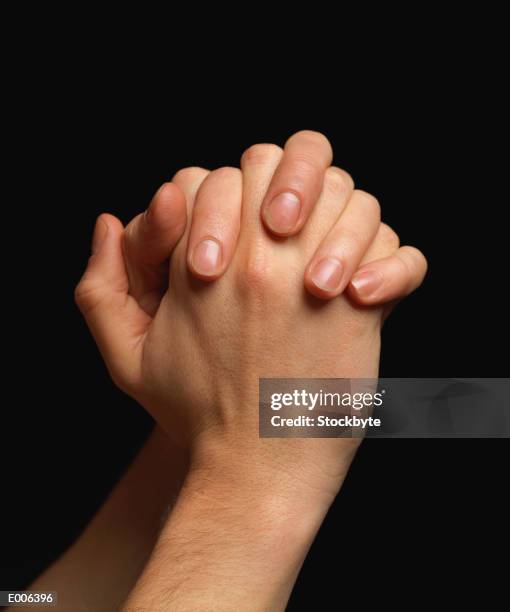 two hands clenched together - rubbing hands together stock pictures, royalty-free photos & images