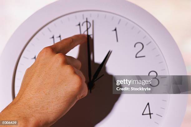 hand changing time on clock - daylight saving time foto e immagini stock