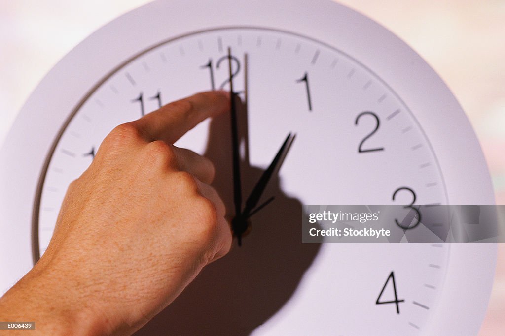 Hand changing time on clock