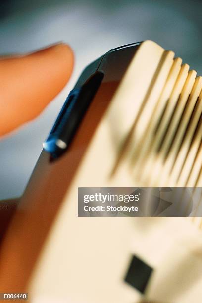 finger pressing button on electronic device - radio control stock pictures, royalty-free photos & images