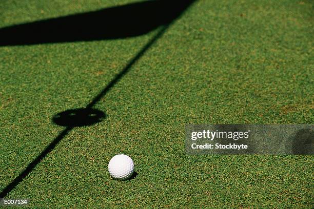 ball on grass by shadow of marker - markierung stock-fotos und bilder