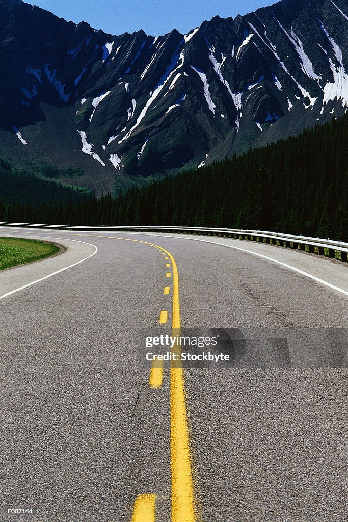 Roadway with dark craggy mountains beyond