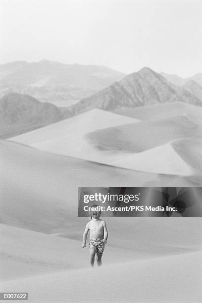 smiling child crossing desert - maxim barron stock pictures, royalty-free photos & images