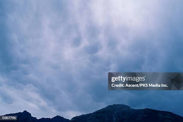 eggshell clouds over mountain range - eggshell stock pictures, royalty-free photos & images