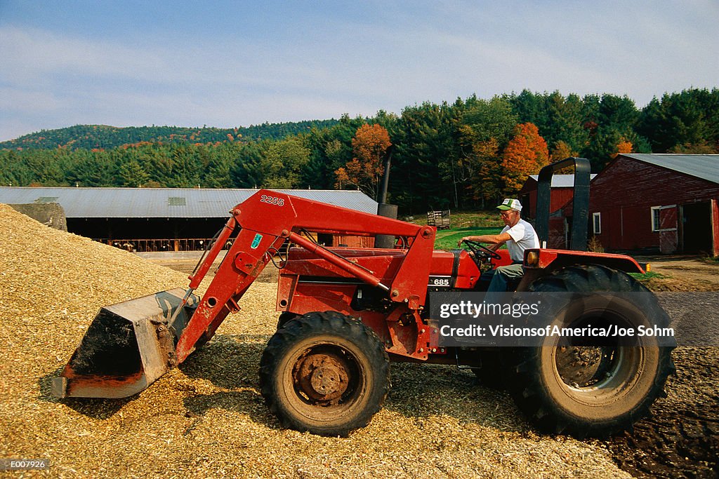 Side shot of farmer on combine harvester