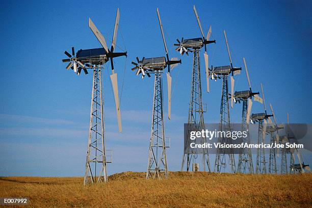 row of wind turbines on ground - altamont pass stock pictures, royalty-free photos & images