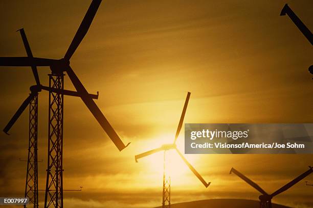 wind turbines against golden sky - altamont pass stock pictures, royalty-free photos & images