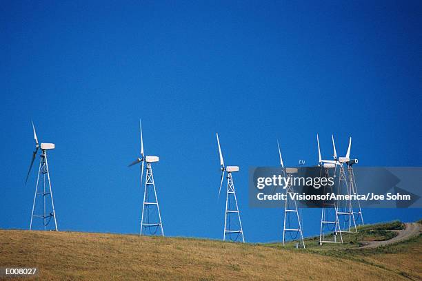 row of windmills on hill - altamont pass stock pictures, royalty-free photos & images