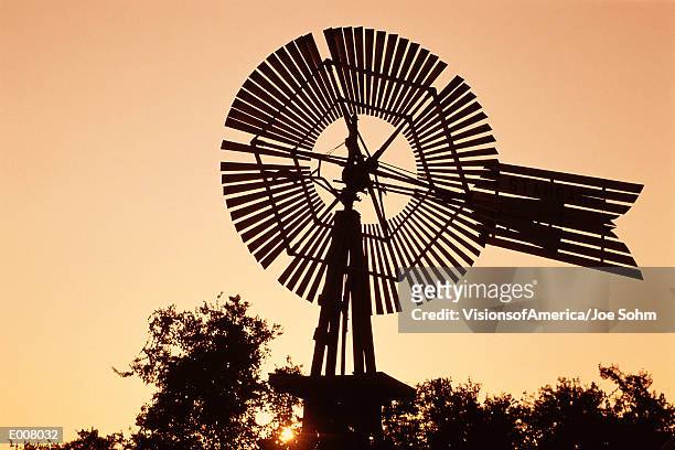 top of windmill against pale orange sky - 工業用風車 ストックフォトと画像
