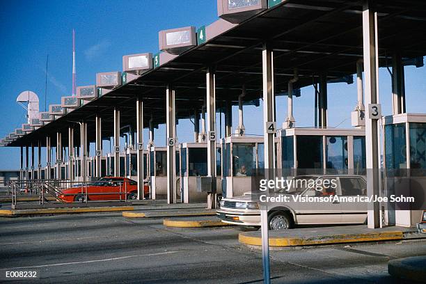 cars emerging from toll booth - toll booth stock-fotos und bilder