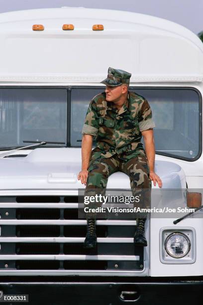 soldier sitting on hood of military bus - us marine corps stock pictures, royalty-free photos & images