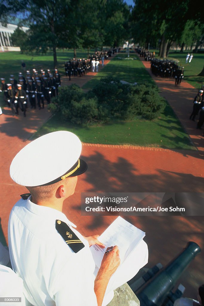 Midshipman checking list at formal dress parade
